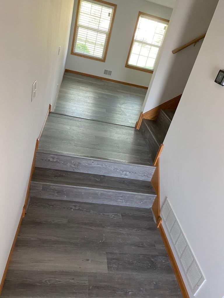 Long gray LVP staircase with white risers
